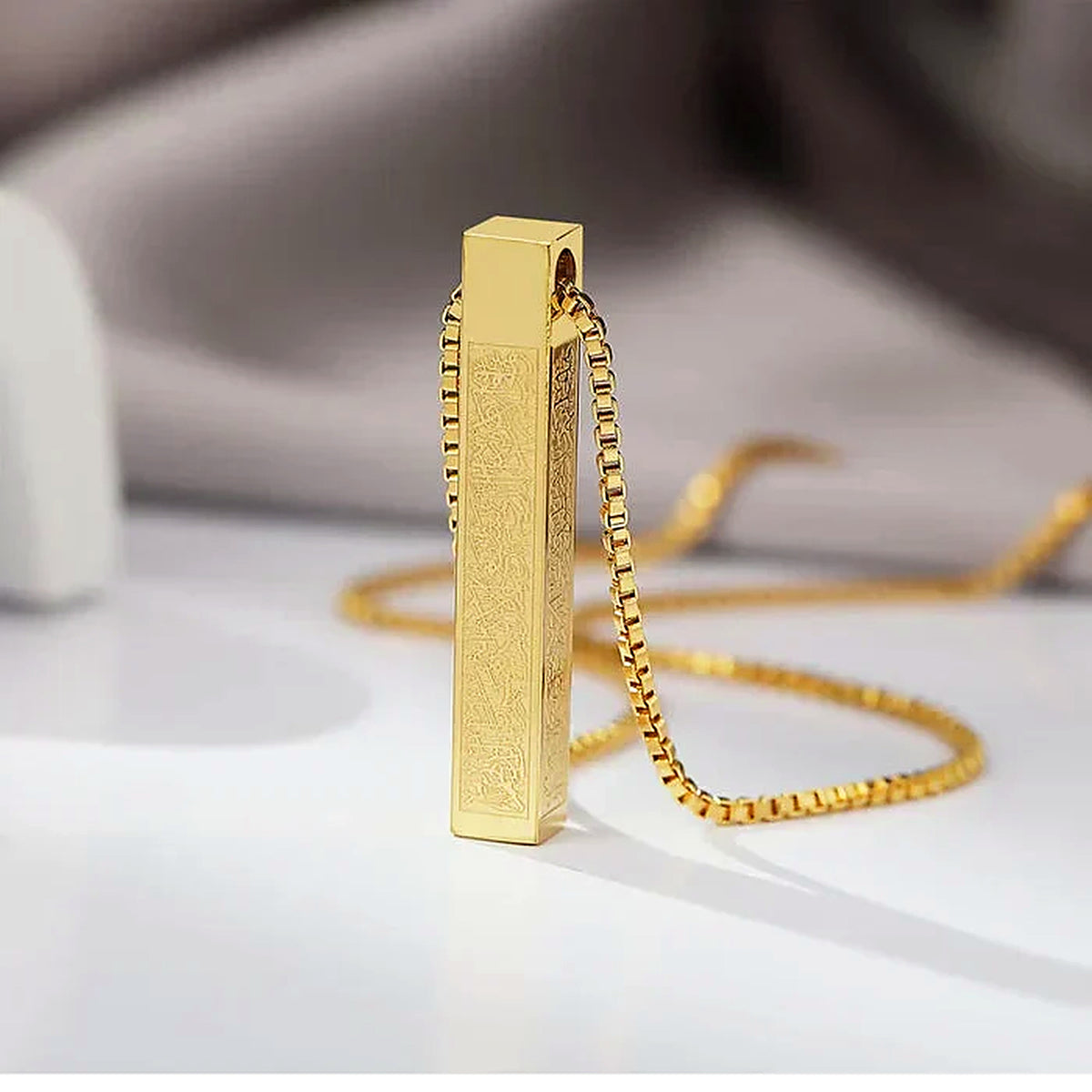 Gold vertical bar necklace engraved with Arabic calligraphy